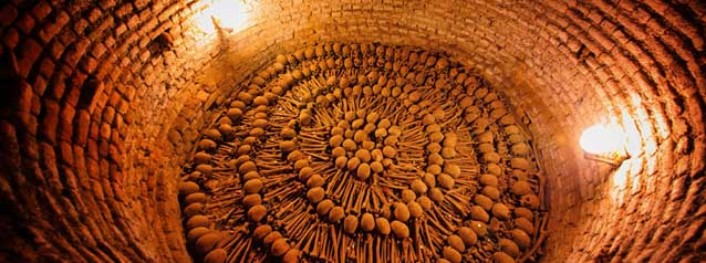 Catacombs of San Francisco tour group are guided through the catacombs in san francisco church, lima.