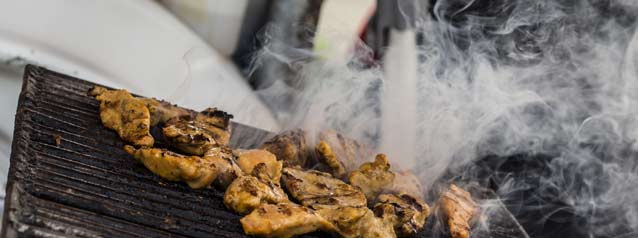 Local street vendor in Lima street vendors cook authetic peruvian food on a hot barbecue for locals and tourists to eat