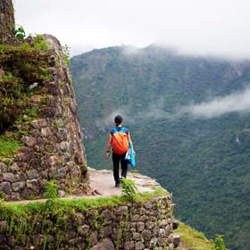 Female solo tourist with a group trip on the Inca trek tour Female solo tourist on group travel trip on the Inca Trail hike enroute to Machu Picchu, Peru