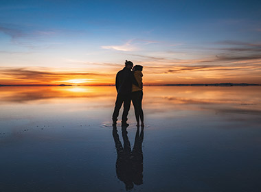 couple watching the sunrise on the Salt Flats in Bolivia Honeymoons to Peru and Bolivia