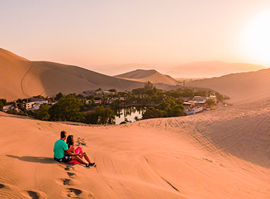 couple enjoying the view of the Huacachina Oasis in Peru peru honeymoons