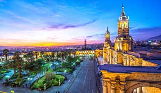 Travel group overlook Arequipa square from a roof-top bar Arequipa is a stunning volcano-ringed colonial-era city in south western Peru