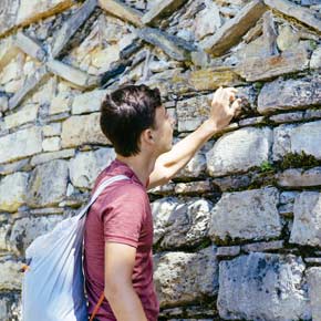 Solo tourist on a group tour ancient ruins in Kuelap Solo traveler on a group tour at the ancient ruins of Kuelap