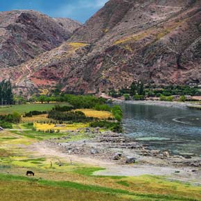 Urubamba River runs between the Andes mountains solo adventure traveller take a photo of their trip to