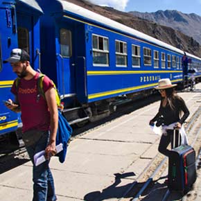 Solo adventure travelers on a group tour boarding the train in Ollantaytambo near Machu Picchu in Peru