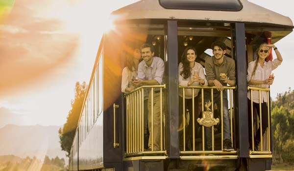 Group tours travel towards Machu Picchu via trains through the valley Group tour in Peru on a train journey from ollantaytambo to Aguas Calientes