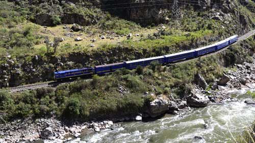 Group tours travel towards Machu Picchu via trains through the valley Group tour in Peru on a train journey from ollantaytambo to Aguas Calientes