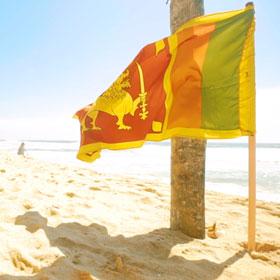 Independence Day celebration with a Sri Lankan flag on Negombo beach, the location where Tucan Travel holiday trips start Independence Day fling the Sri Lnakan flag on Negombo Beach where Tucan Travel trips & tours start in Sri Lanka