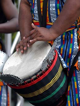 Wanyambo Festival, Tanzania man playing traditional african drums at wanyambo festival in tanzania
