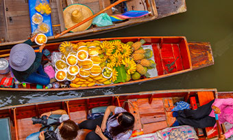 A floating market near Ratchaburi, Thailand A boat selling fruit and vegetables at the floating markets in Bangkok, Thailand