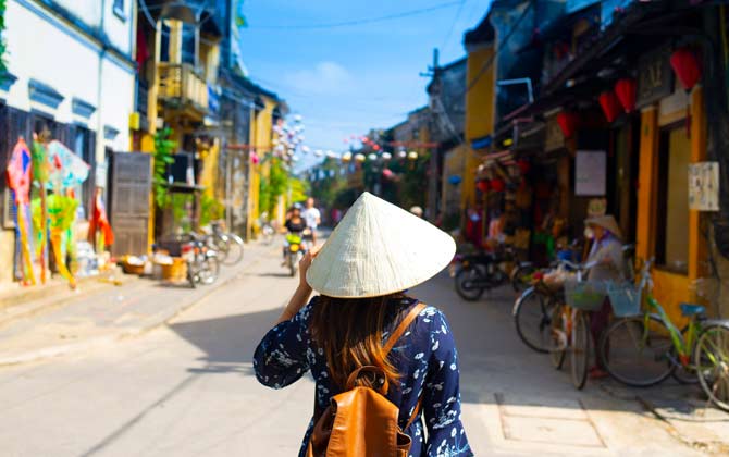 Solo female traveller on an adventure through the old town of Hoi An, a UNESCO world heritage site
