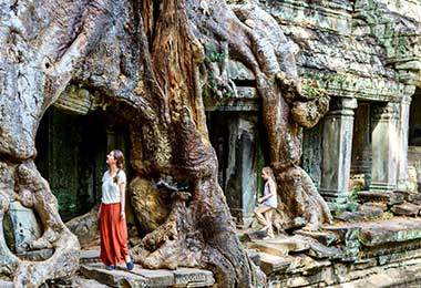 Girl exploring the temple complex of Angkor Wat on family holiday