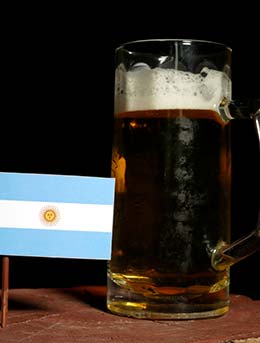 Argentinian flags next to a pint of beer for Oktoberfest in Argentina