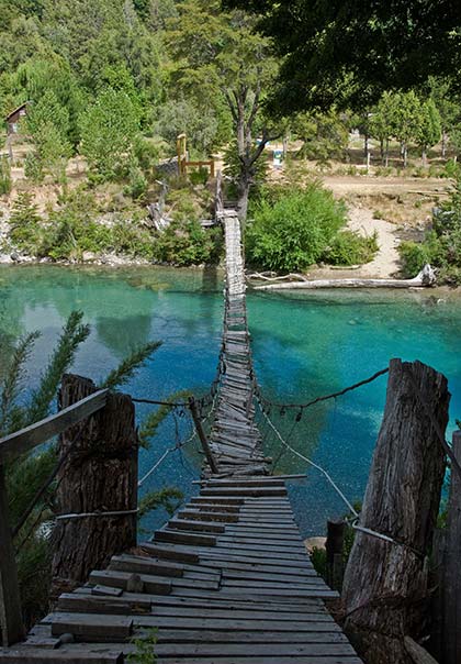 rickety bridge leading over the river in argentina