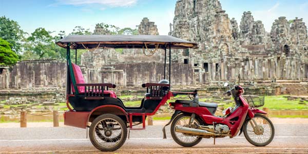 Taxi outside of a temple in Cambodia Taxis, motorbikes and tuk-tuks offer an great opportunity to explore the country of cambodia for all tourists on holiday