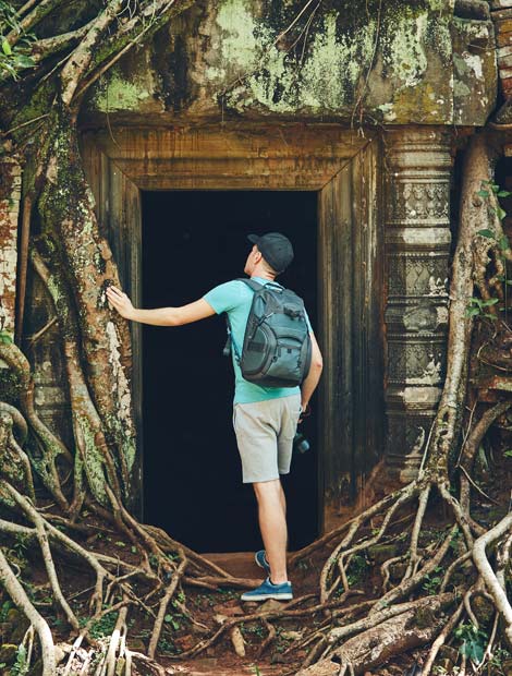 Holiday adventure tourist explore the door way on ancient ruins in the amazing Angkor Wat
