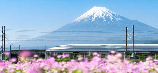 Shinkansen bullet train passing by Mount Fuji Shinkansen bullet train passes by Mount Fuji Yoshiwara