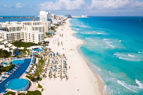 Cancun Beach sunloungers and pools along the white stretch of sand on cancun beach in mexico