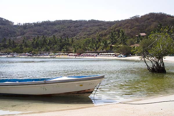 Playa las Gatas boat floating in the water in the cove of playa las gatas one of the best beaches in mexico