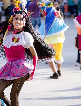 Festival de Mexico people dancing in the street wearing costumes for festival de mexico