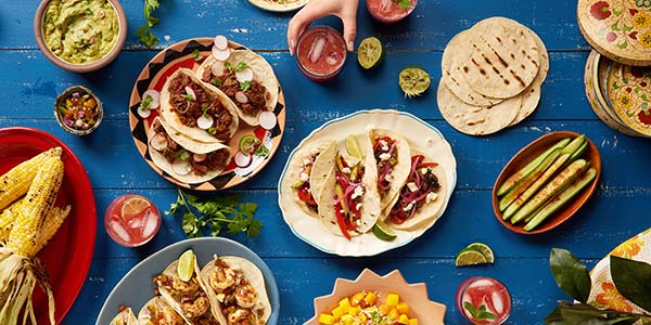 Cost of food & drink in Mexico spread of mexican food on a blue table
