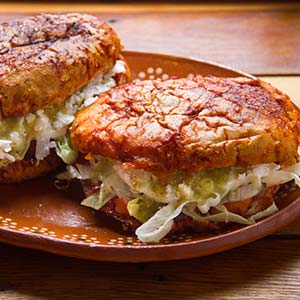 pambazo is a mexican sandwich fried in chili sauce