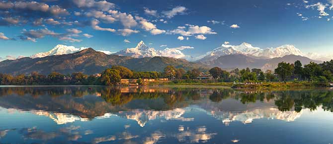 Holiday group tour visitis the amazing lake at the foot of the annapurna foothills