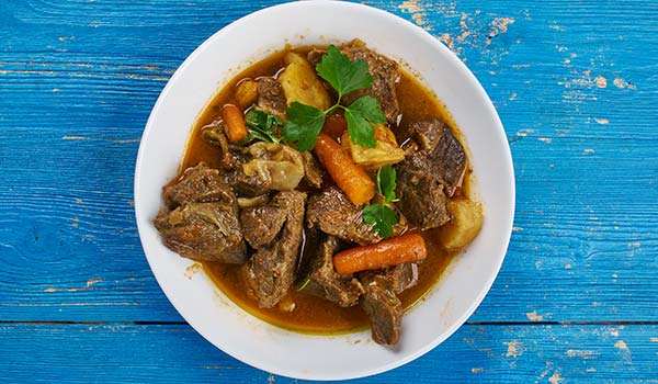 Popular food in South Africa - Cape Malay Curry cape malay curry with vegetables on blue wooden table