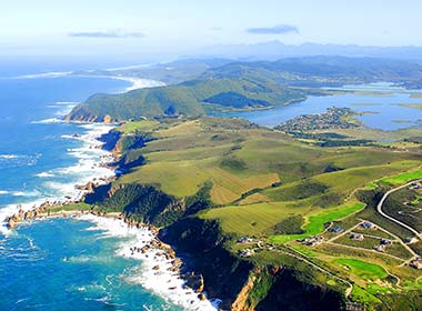 view of the garden route fields sea and green countryside south africa