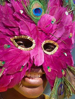 Zimbabwe International Carnival man wearing mask made out of pink feathers for the zimbabwe international carnival