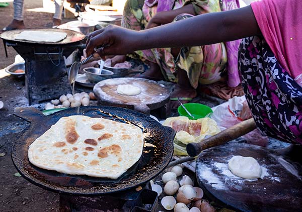 women cooking traditional food on a market in zimbabwe