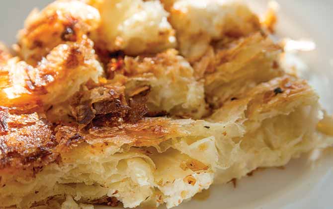 Balkan Bakery Breakfast Serving of Byrek me Gjizë (Cheese Pie with Feta & Flaky Filo Pastry best food to try in eastern europe is byrek in tirana albania