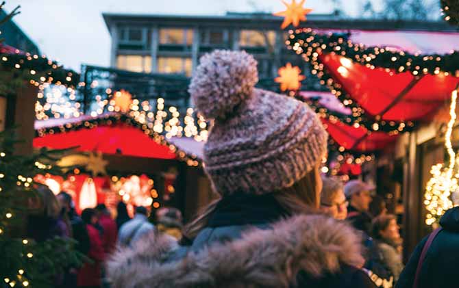 haggling in europe, solo female traveller shopping at a christmas market in europe