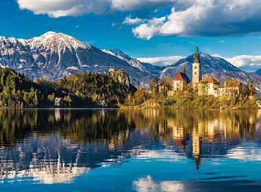best places to visit in eastern europe is lake bled with church on island in slovenia