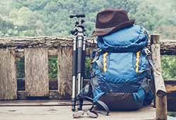 What to pack for a vacation to Europe What to pack for a holiday to Western Europe. Blue backpack with a camera tripod