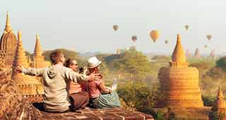 travel group in myanmar bagan witnessing the hot air ballloons flying over the ancient ruins