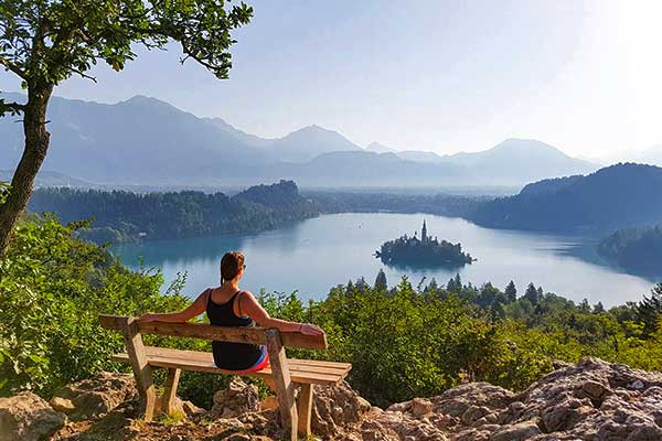 solo traveller on an escorted adventure trip through in Europe enjoying the view over lake