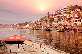 sailing a boat on the holy river ganges in varanasi on a spiritual tour of india
