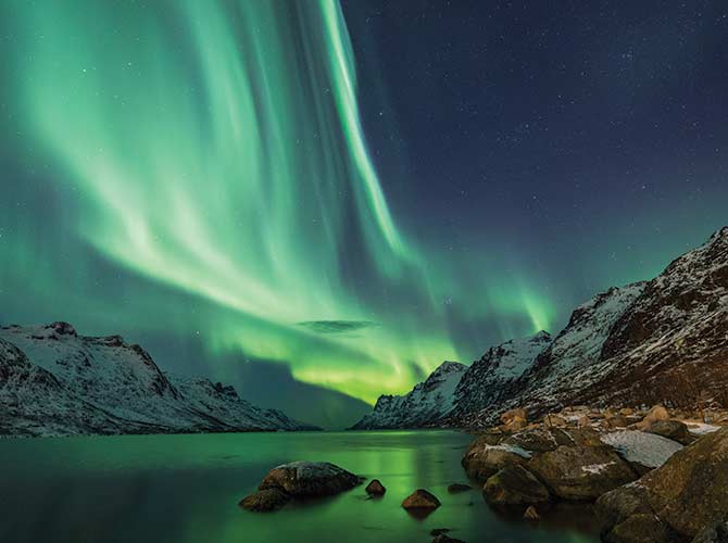 The Northern Lights / Aurora Borealis in Iceland green aurora borealis in the night sky above a river in Iceland watching the northern lights