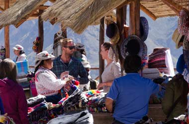 couple purchasing from local markets in the colca canyon on an adventure holiday in peru