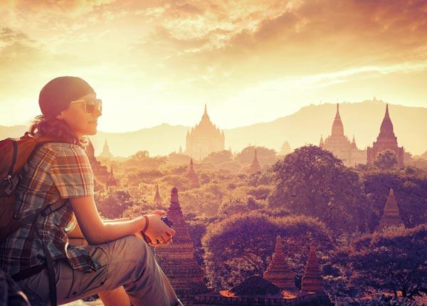 single traveler in awe of her surroundings with the view over the ancient city of Bagan, Myanmar