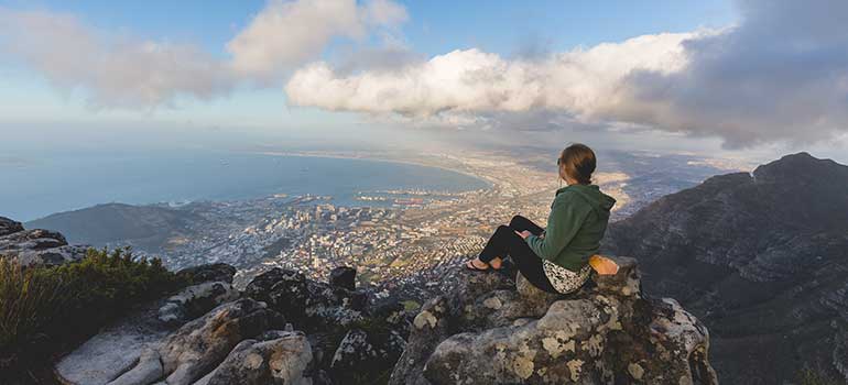 Traveller enjoying the view from Table Mountain south africa is a great destination for your holiday in september, where to go in september
