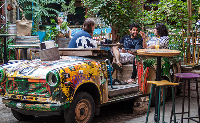 Travellers enjoying a break in the Szimpla Kertz Ruin Bar in Budapest stay in your bubble, private departures, travel with friends, private group travel