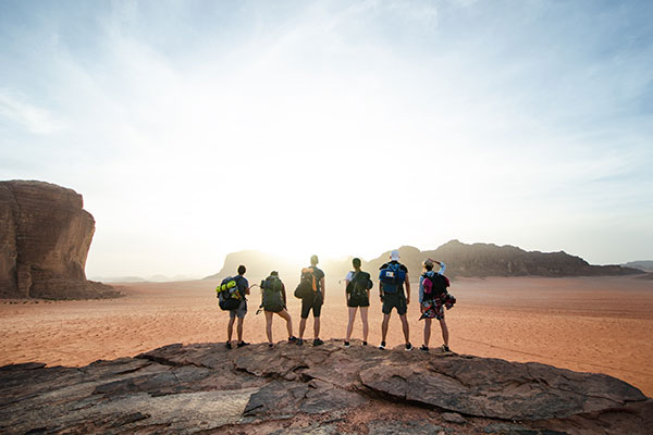 Friends travelling together overseeing Wadi Rum Jordan group travel, private tours to jordan, wadi rum