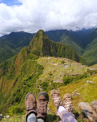 Travellers enjoying the view of Machu Picchu after completing the Inca Trail Trek in Peru Hikers enjoying the view of Machu Picchu after completing the Inca Trail Trek