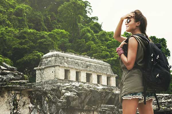 Single travller explores solo traveller on holiday exploring the histroic mayan ruins in mexico's uxmal destination uncovers history and wonder
