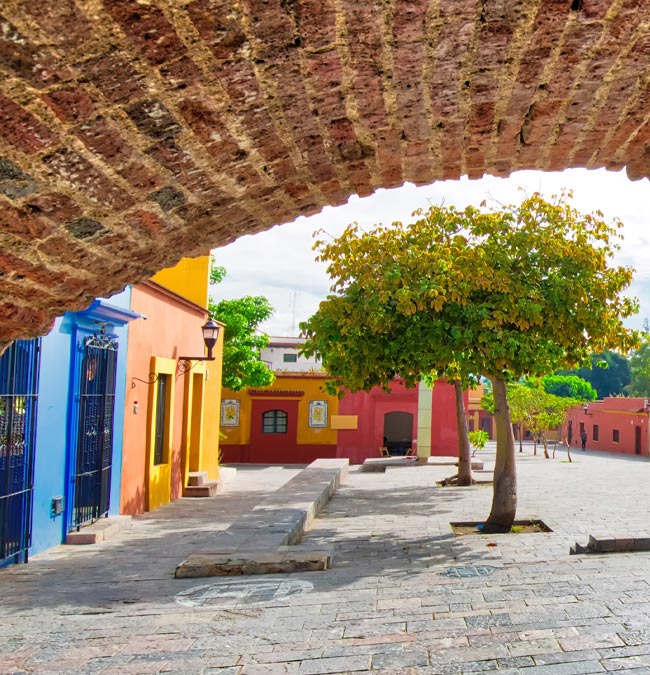 A colourful street through an arquito Explore the arquitos in Xochimilco