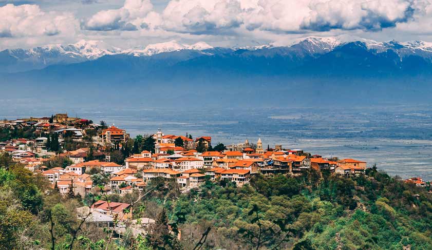 A beautiful panoramic view of Telavi city in Georgia. Caucasus mountains and blue sky with clouds on the background A beautiful panoramic view of Telavi city in Georgia. Caucasus mountains and blue sky with clouds on the background