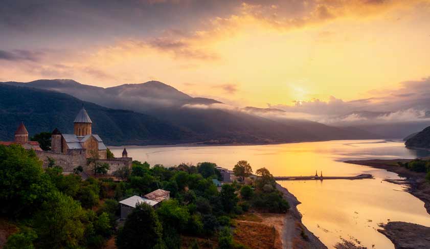 Scenic view of Ananuri fortress and lake at colorful sunrise, Country of Georgia