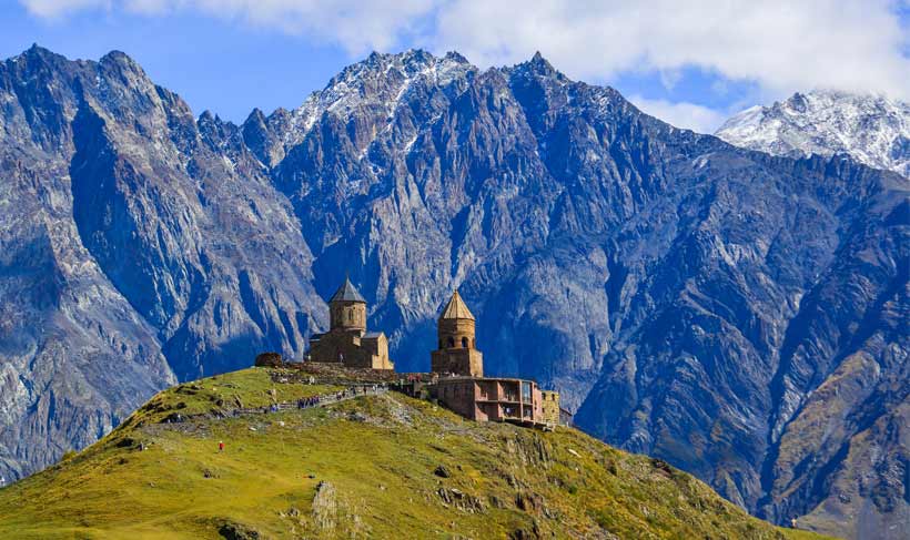 View of Gergeti Trinity Church (Tsminda Sameba) in Kazbegi, Georgia. The Church near the village of Gergeti, under Mount Kazbegi View of Gergeti Trinity Church (Tsminda Sameba) in Kazbegi, Georgia. The Church near the village of Gergeti, under Mount Kazbegi